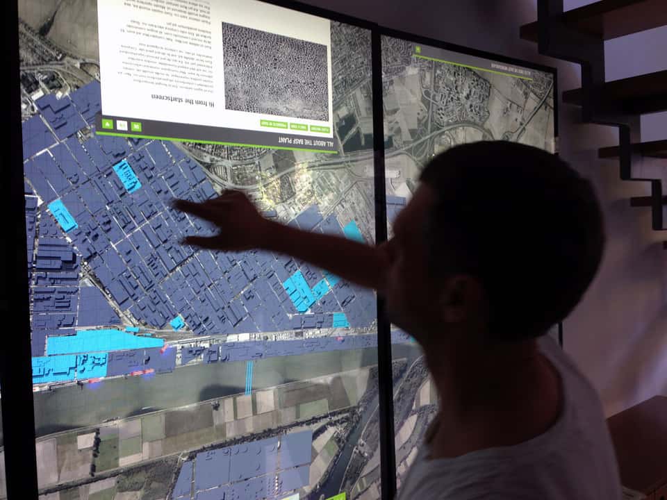 Developer interacting with a high-resolution site map during early interface testing of the BASF media table.