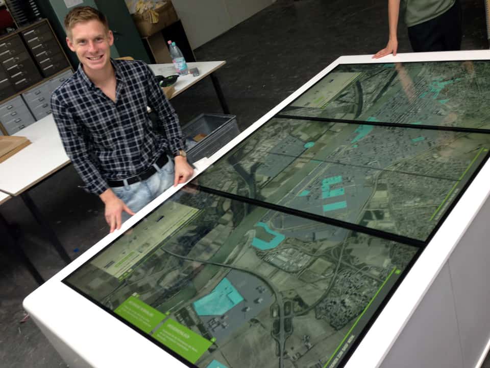 Developer validating interaction and display alignment on the BASF media table during R&D testing.