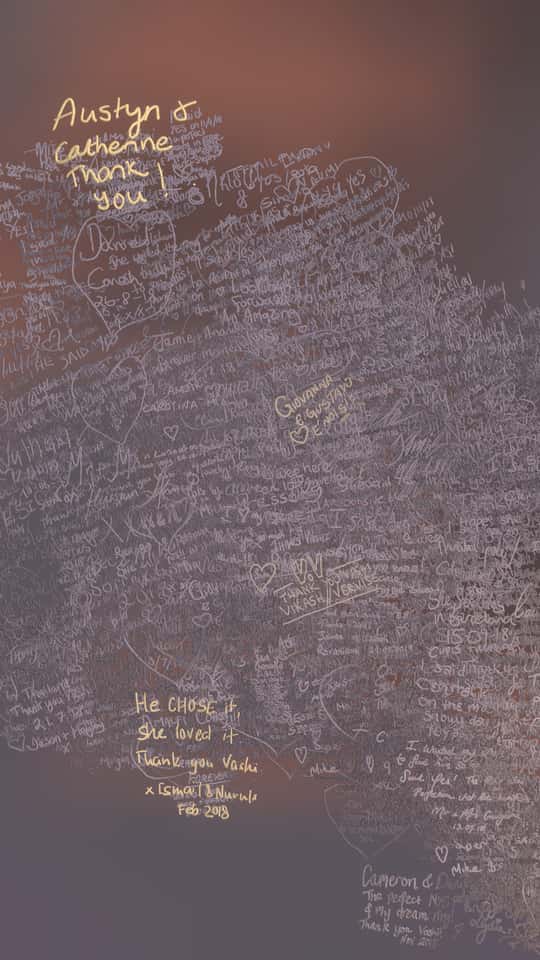 Still of the VASHI Love Wall installation showing a colorful cloud of animated particles forming hand-drawn shapes and messages.